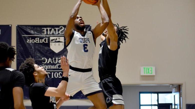 Penn State DuBois senior guard Jaiquil Johnson attempts a put back shot in the paint, with defenders all around him, during a recent game played at the PAW Center.